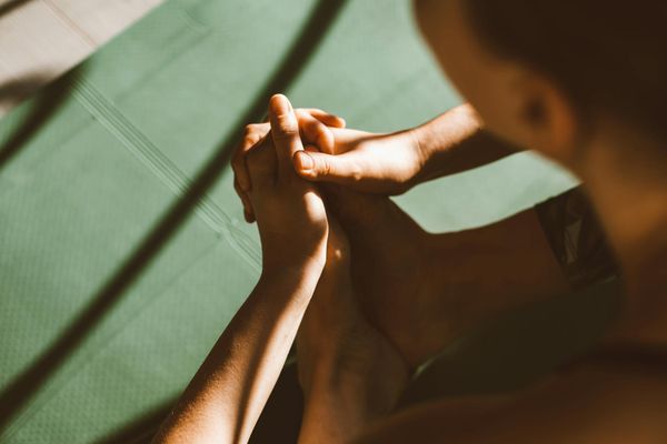 Close-up of hands in a mindful gesture during yoga practice.
