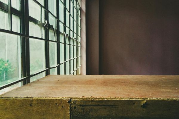 Empty yoga studio with natural light coming through a large window.